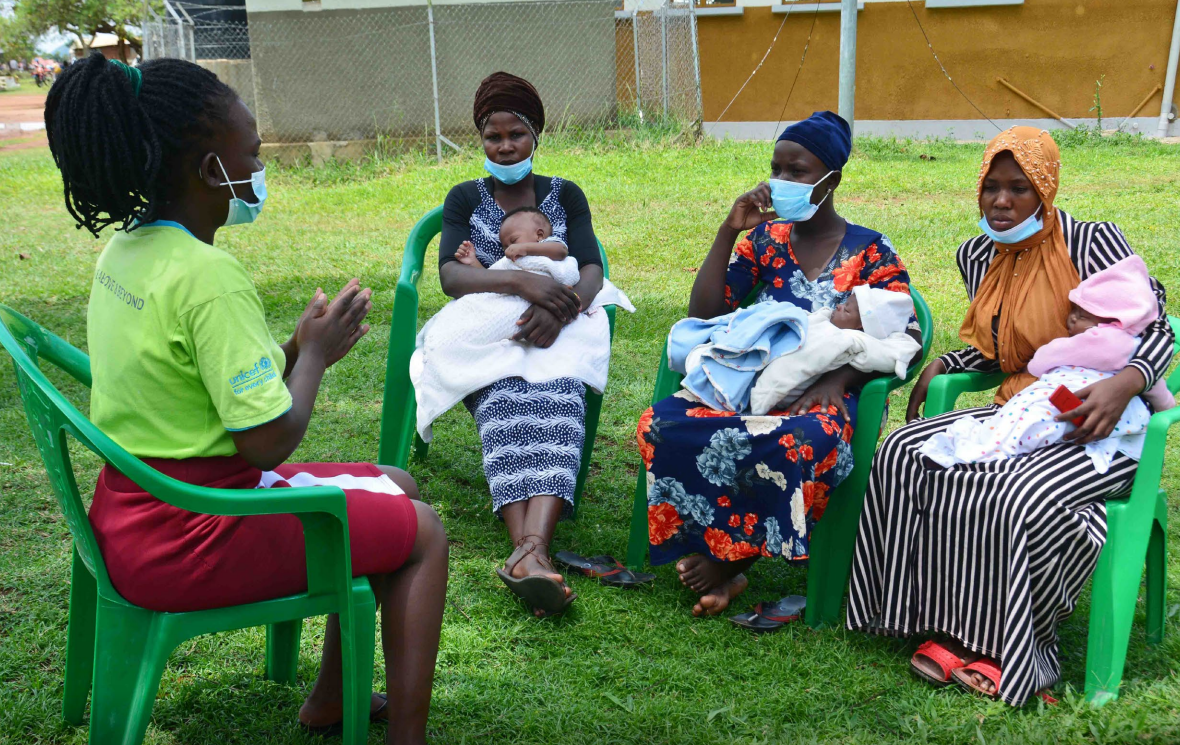 UNICEF Uganda/2021/Francis Emorut Rebecca, a peer educator, talks to young mothers on the grounds of Buyinja Health 1V Centre.